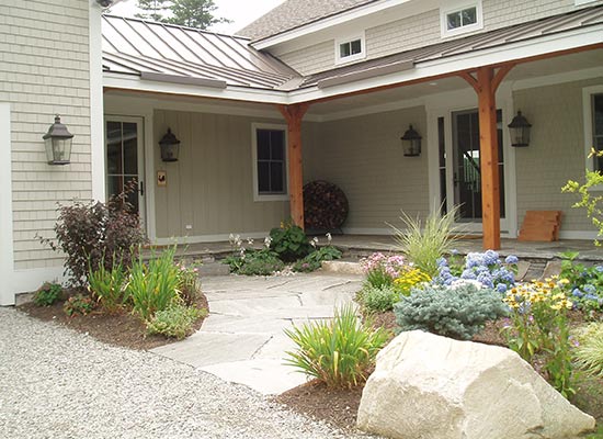 Picture of entrance with stone walkway and plantings