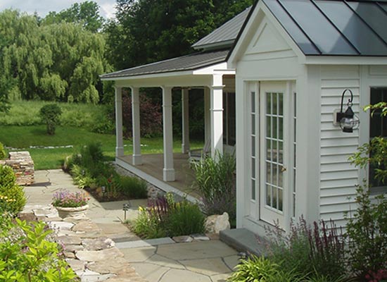 Picture of white porch with walkways and landscaping