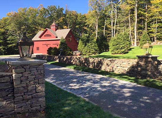 Picture of stone wall driveway entrance with lanterns