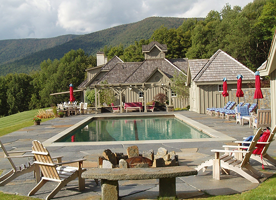 Picture of home in the mountains with a pool and large stone patio