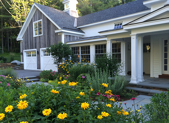 Picture of home entrance with walkway and yellow flowers