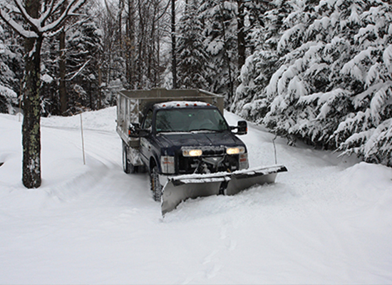 Photo of truck plowing a driveway