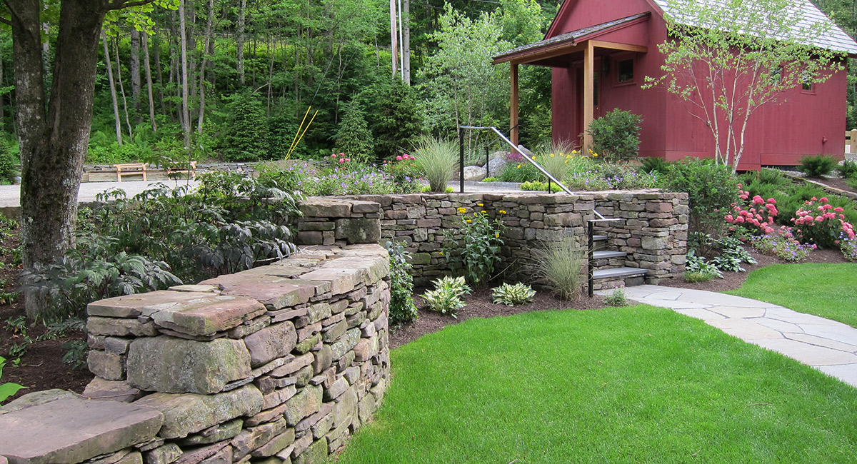 Stone retaining walls, stairs & landscape plantings